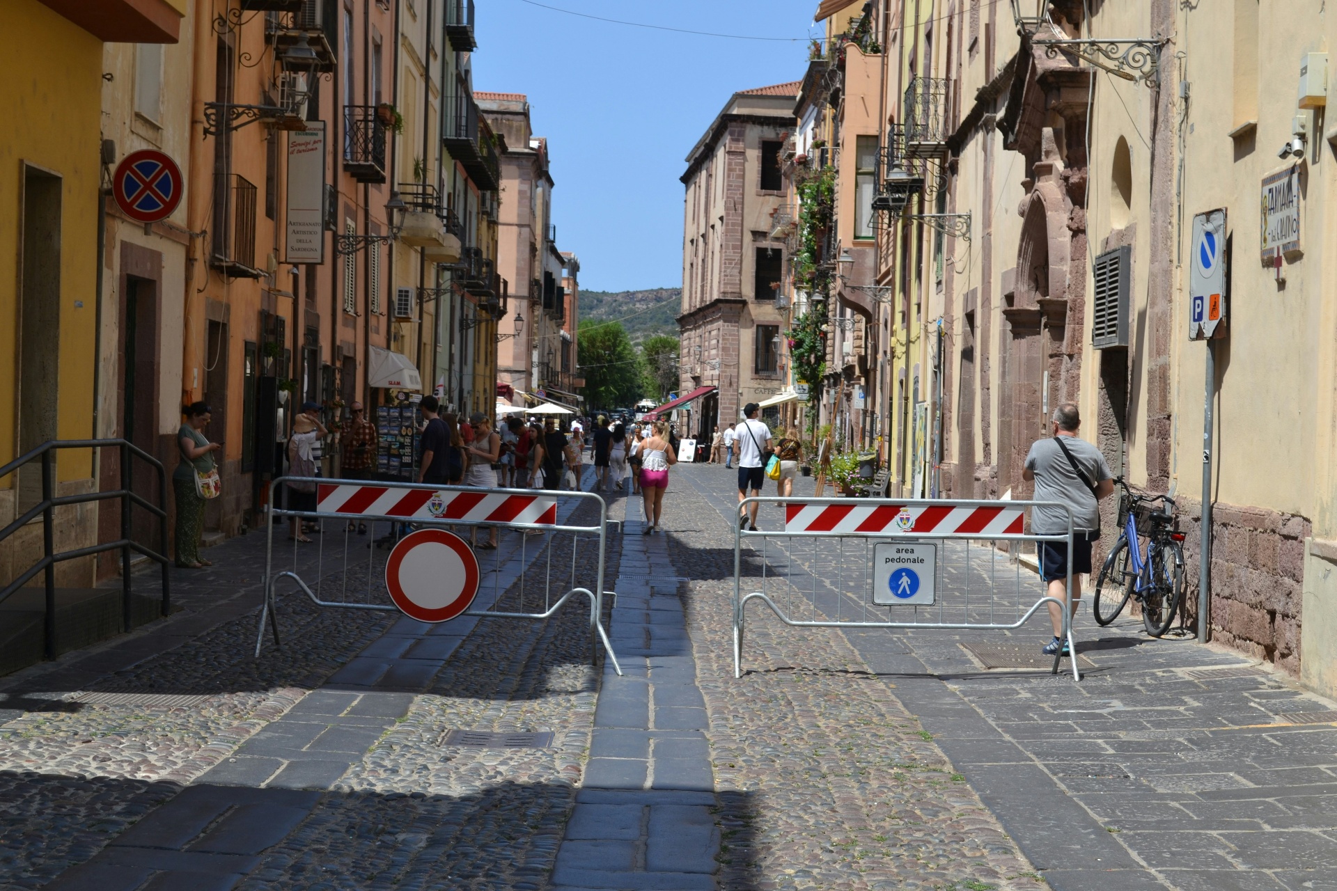 Aerial view of a coastal village with tiled rooftops and narrow streets